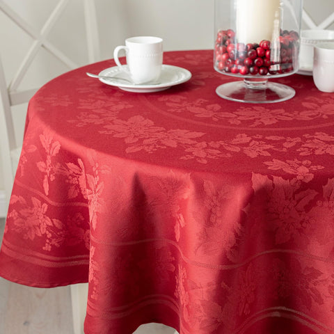 Benson Mills front view of 70 inch dark red round tablecloth showing holly pattern and elegant drape