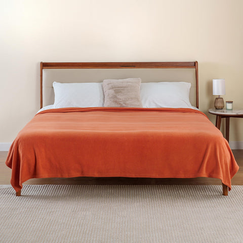 Berkshire Blanket used on sofa in living room showing vibrant color and comfort