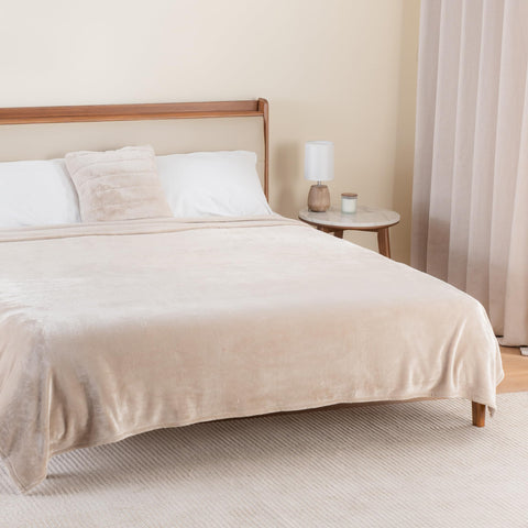 Berkshire Blanket draped over a couch offering cozy decor and everyday use