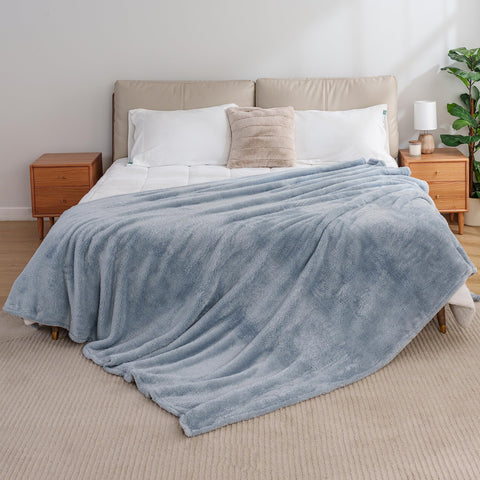 Berkshire Blanket folded on sofa demonstrating large throw size for shared use