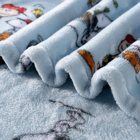 Berkshire Blanket Snoopy on sofa lifestyle image shows decorative and snuggling benefit