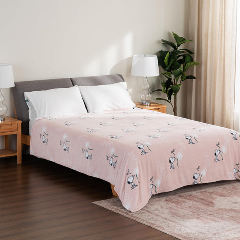 Berkshire Blanket next to person to illustrate king 90 by 108 inch coverage
