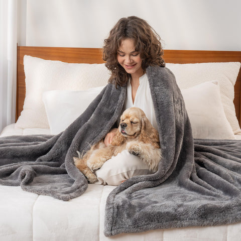 Berkshire Blanket on sofa with two people sharing warmth and softness