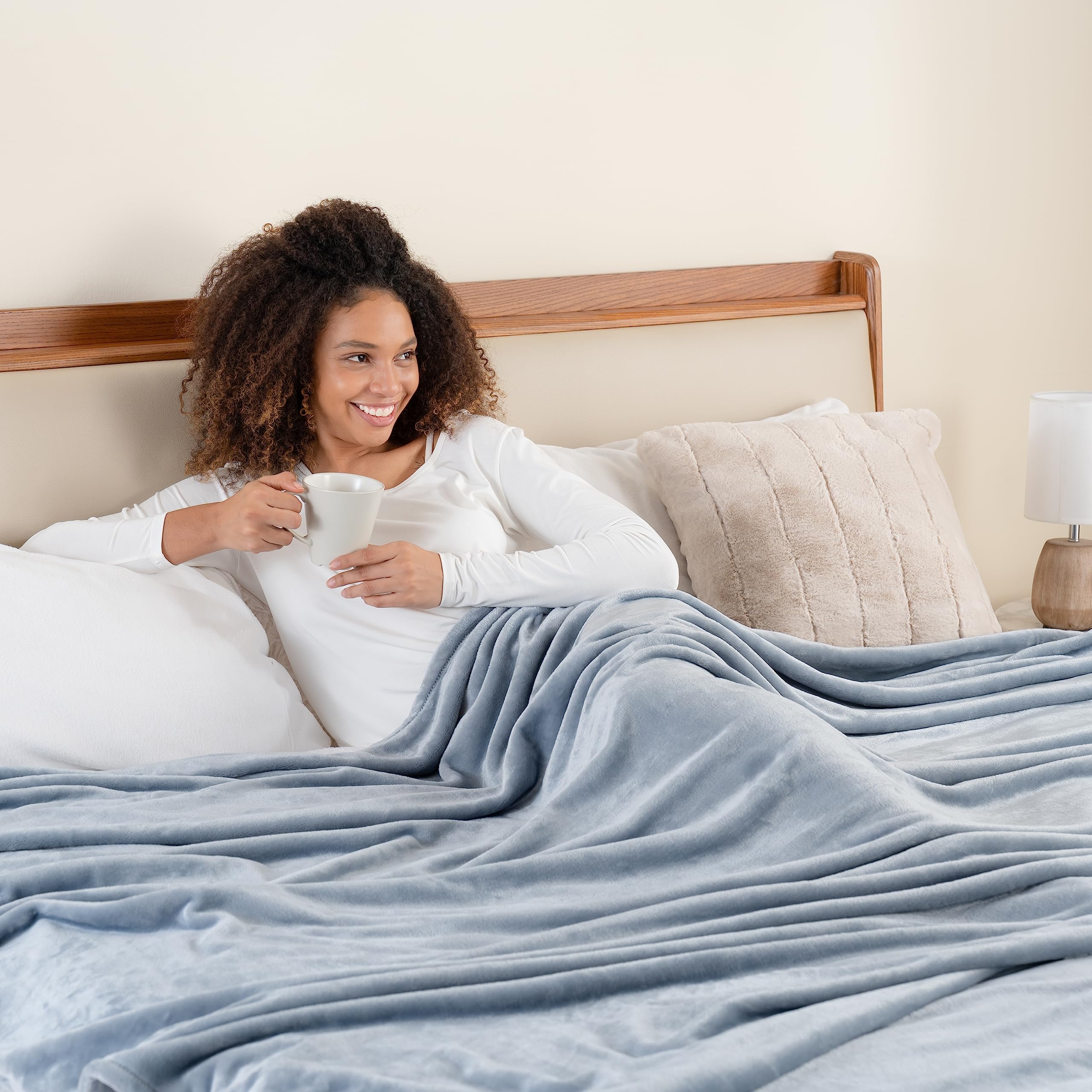 Berkshire Blanket hand pressing plush surface showing tactile softness and lasting plush feel