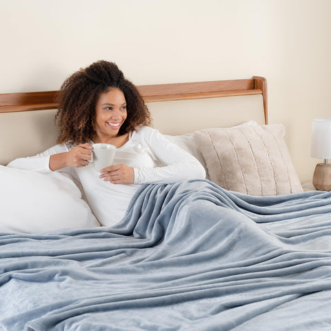 Berkshire Blanket hand pressing plush surface showing tactile softness and lasting plush feel