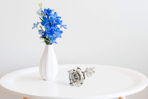 BESZONE tin rose held in hand for scale showing compact keepsake and weight
