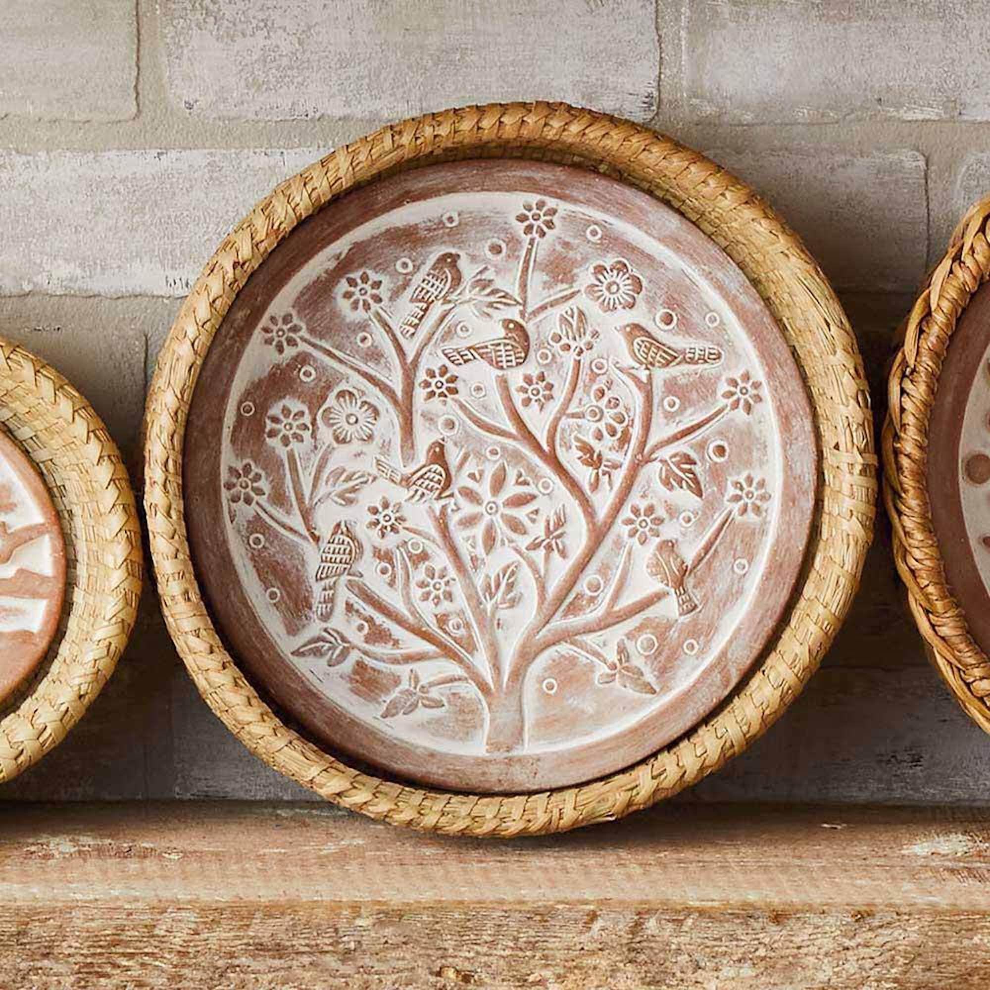 Better World Bio close-up of terracotta warmer engraved Birds of a Feather design demonstrates decorative warming benefit