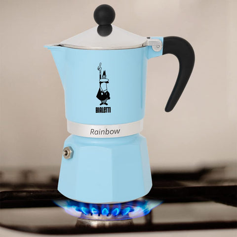Bialetti Rainbow in a kitchen scene pouring espresso, showing convenience and colorful style