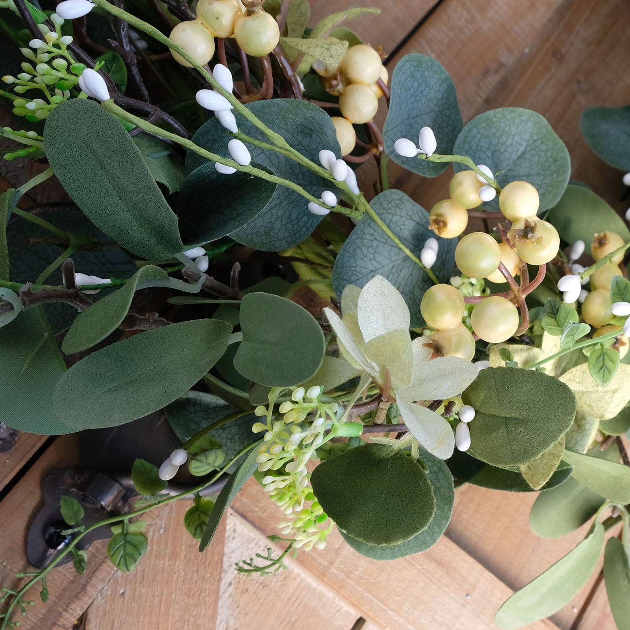 Bibelot wreath with hand showing size and lightweight hanging benefit