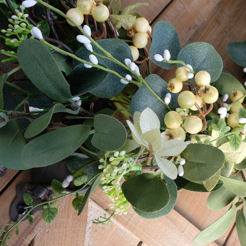 Bibelot wreath with hand showing size and lightweight hanging benefit