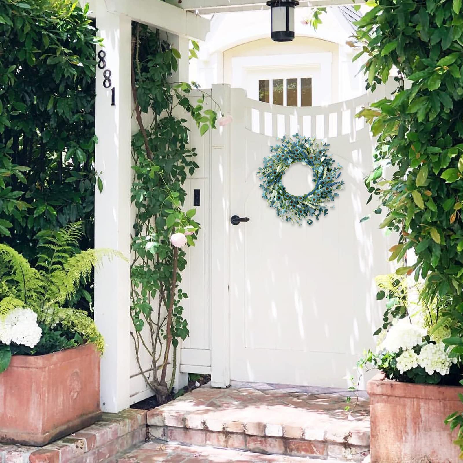 Bibelot wreath displayed on a covered front door adding farmhouse charm