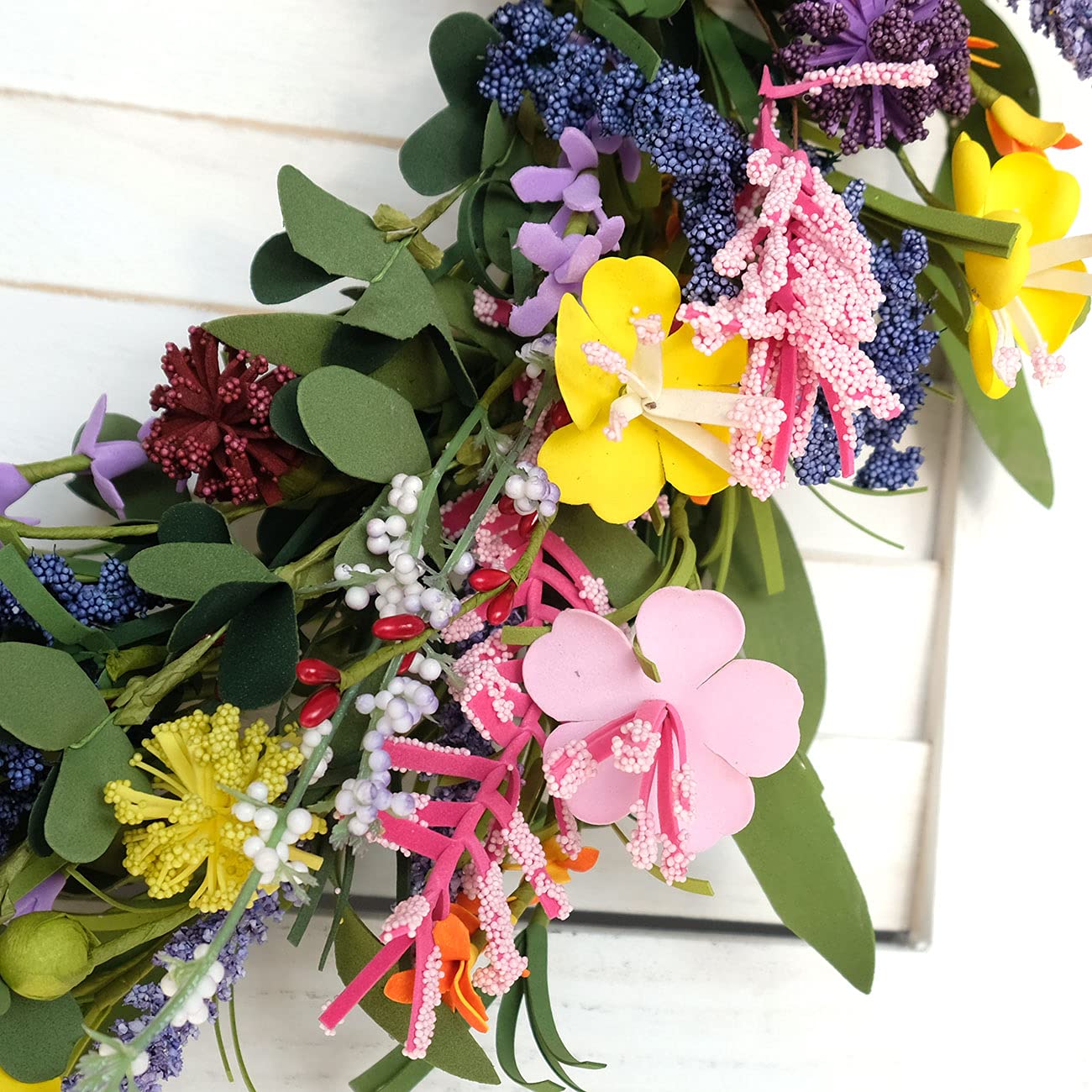 Bibelot wreath styled on indoor mantel creating cheerful room accent