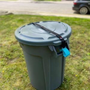 BinClaw strap fastened across lid and handles to show secure attachment