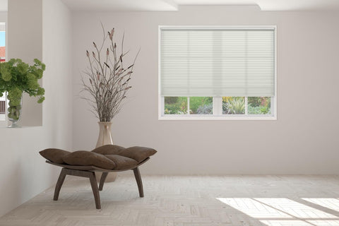 BlindsAvenue hand pulling shade down demonstrating cordless Free Stop operation and ease