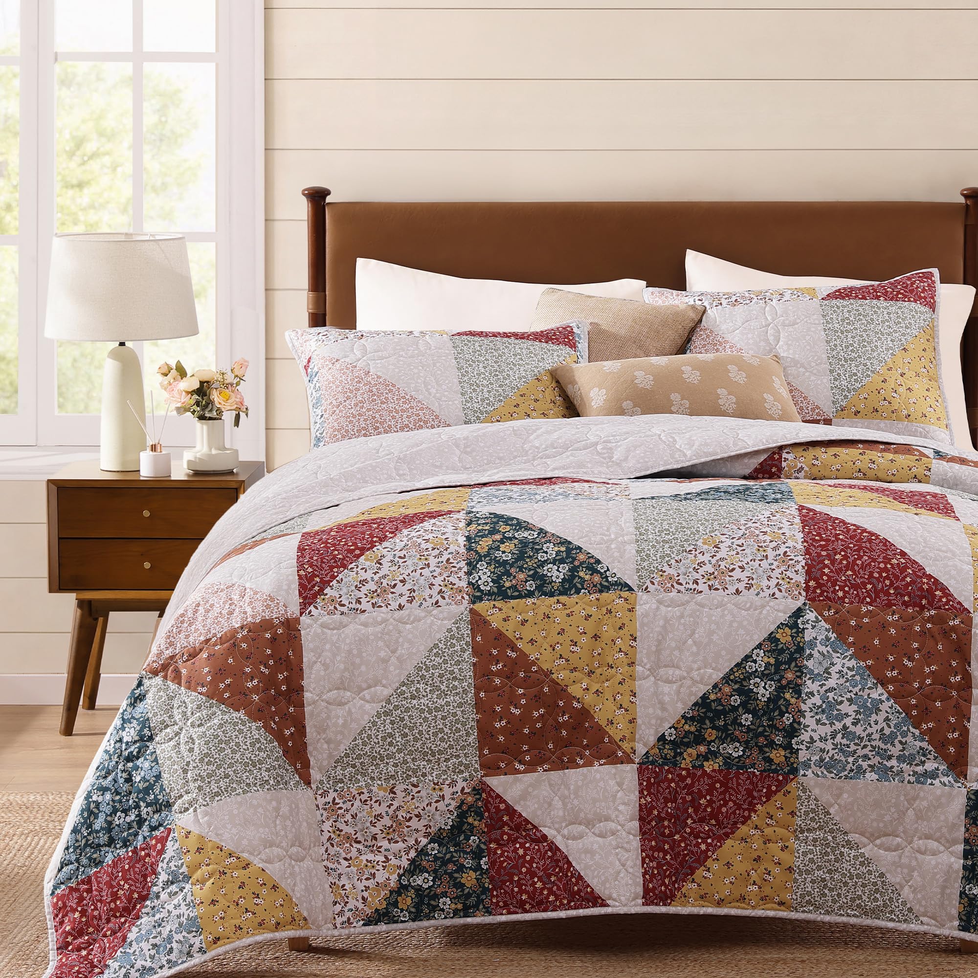BLOOMHAVEN front view of quilt showing floral patchwork and inviting warmth