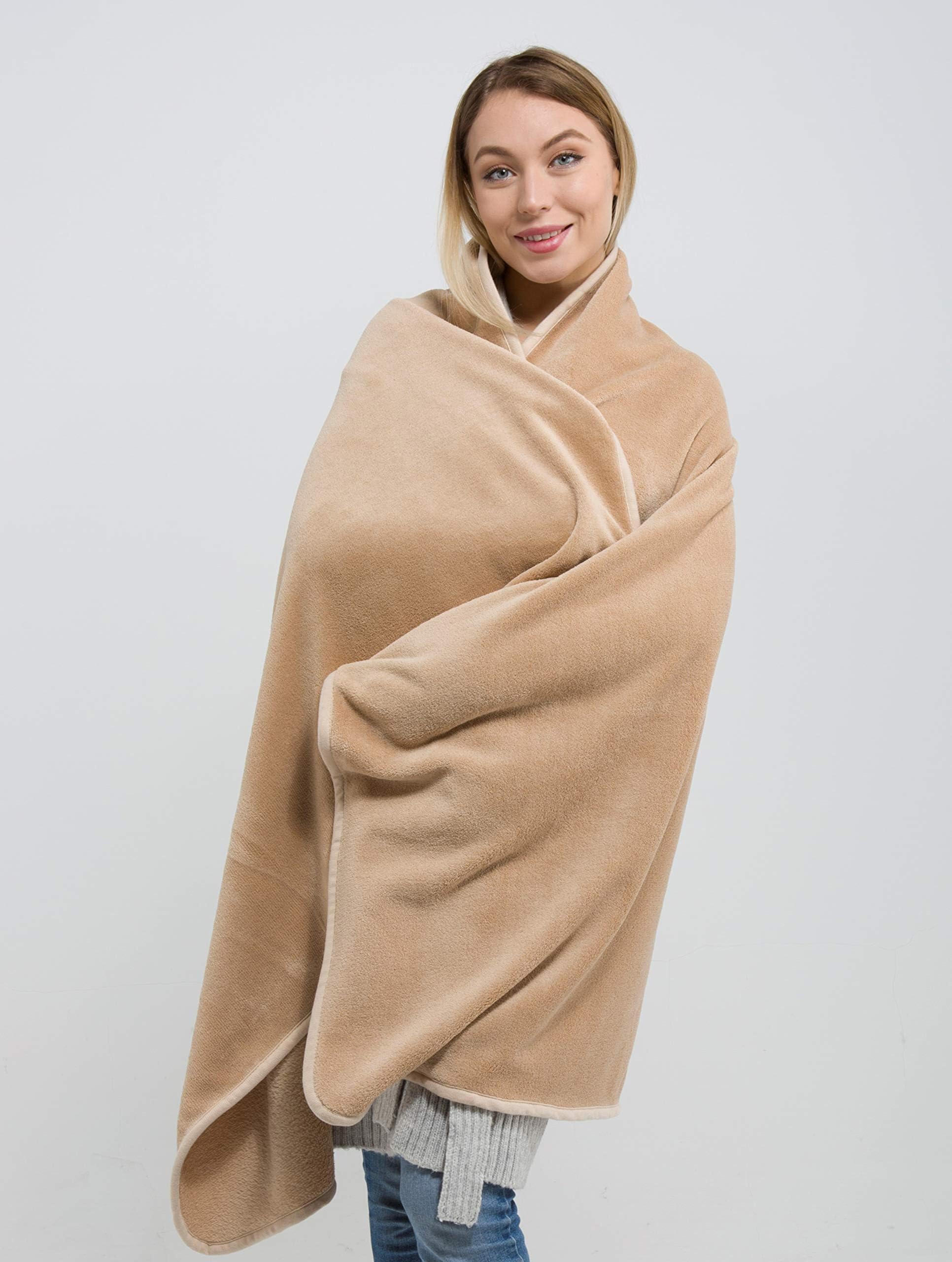 BlueHills blanket on airplane seat providing warmth and travel comfort