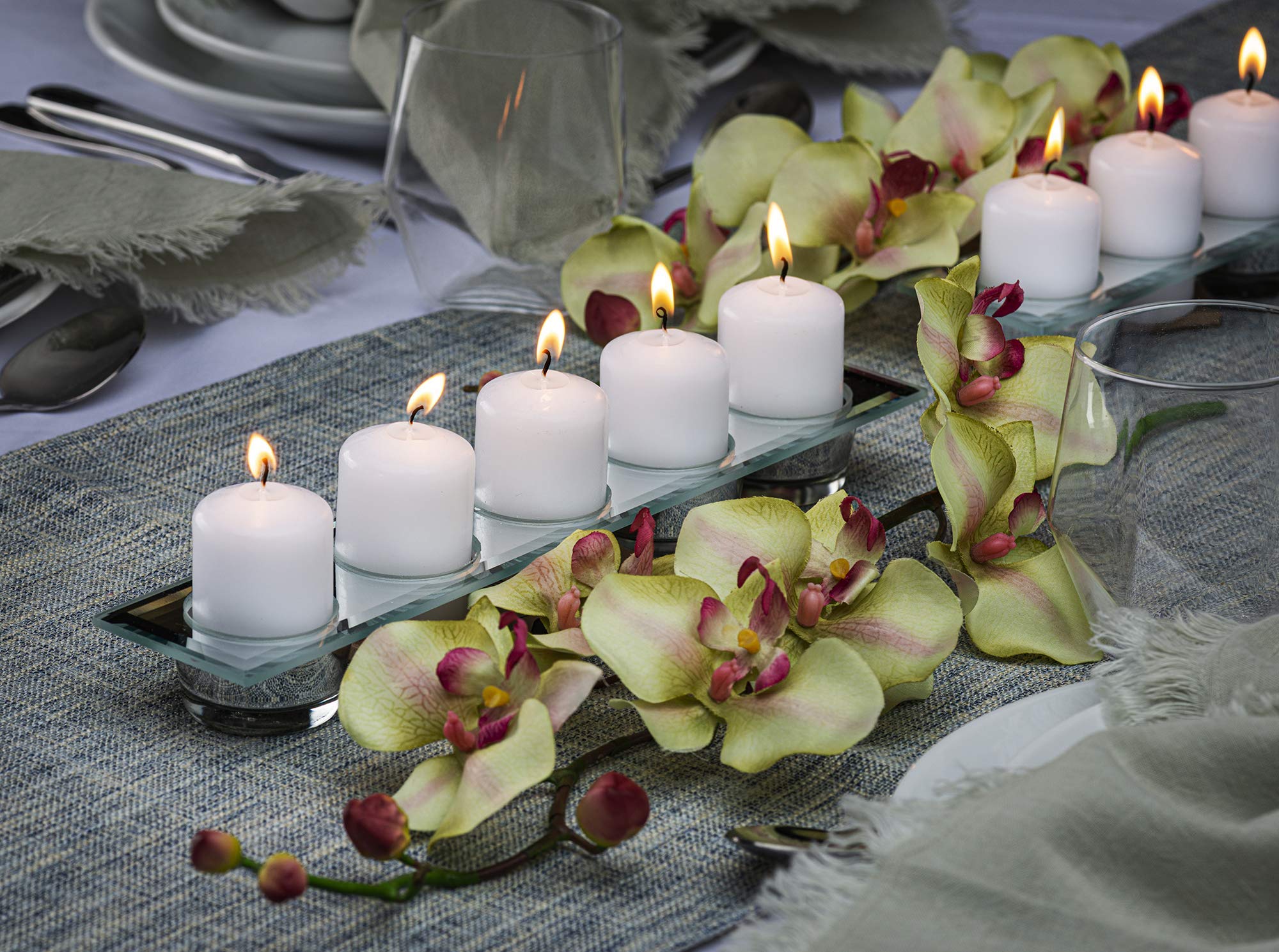 BOLSIUS lit candle in centerpiece creating warm, calm ambiance for dining