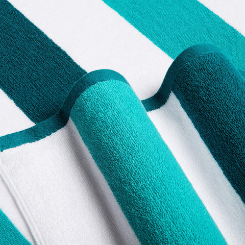 Bornbay towel on sandy beach in use offering sand-free lounging benefit