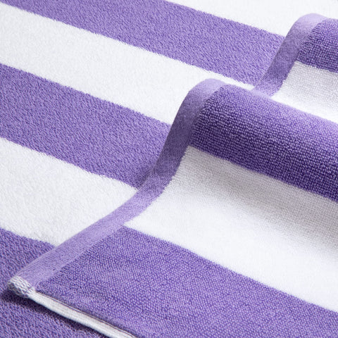 Bornbay towel beside hat and sandals showing size comparison and travel convenience