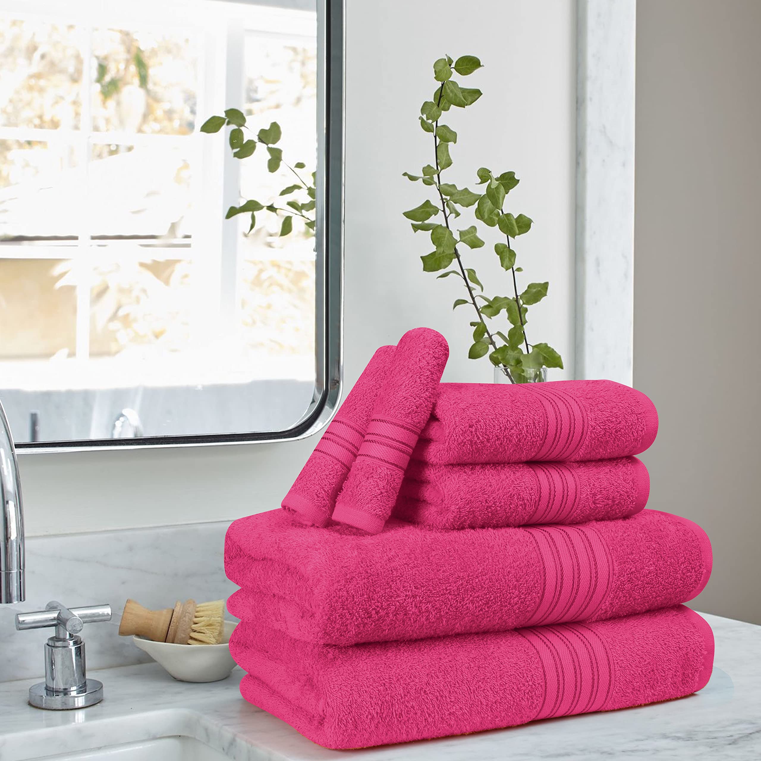 BOUTIQUO stacked set display demonstrating coordinated towels and neat storage