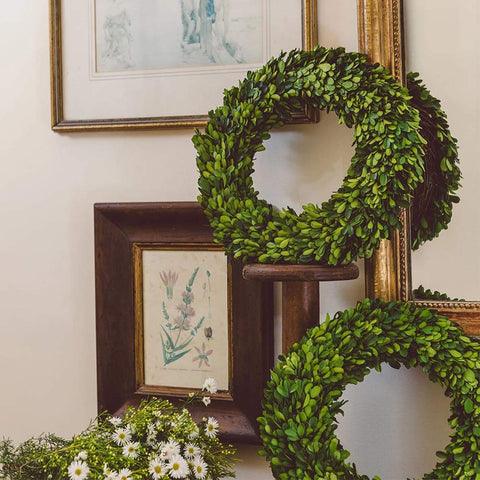 BOXWOOD WORLD wreath displayed on mantel showing how it enhances living room ambiance
