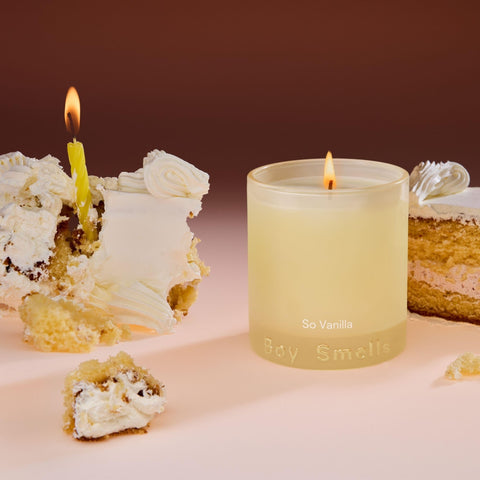 Boy Smells candle on coffee table with blanket showing cozy setting benefit: inviting comfort