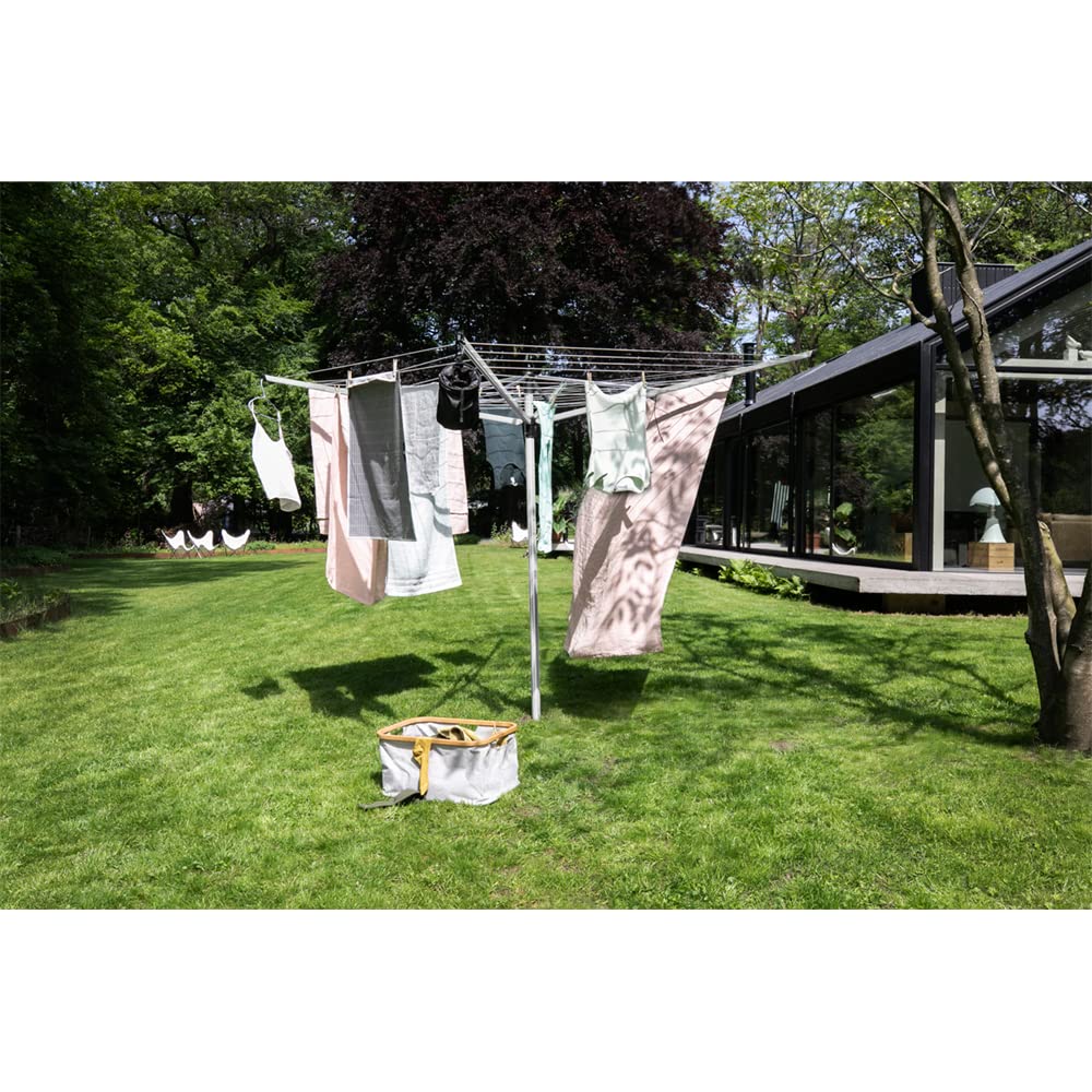 Brabantia clothesline in use with wet laundry drying, saving energy outdoors