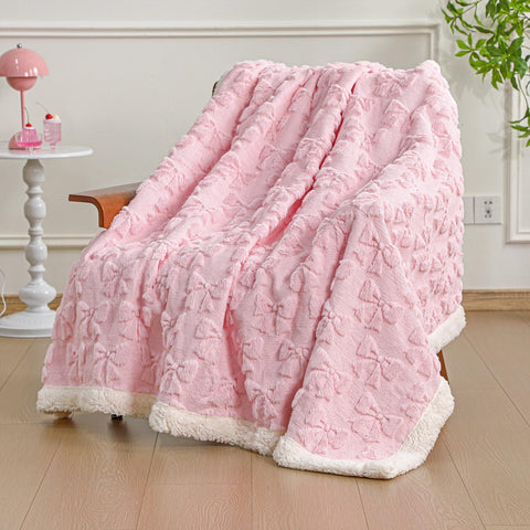 Breling bow throw front view showing pink plush and decorative appeal