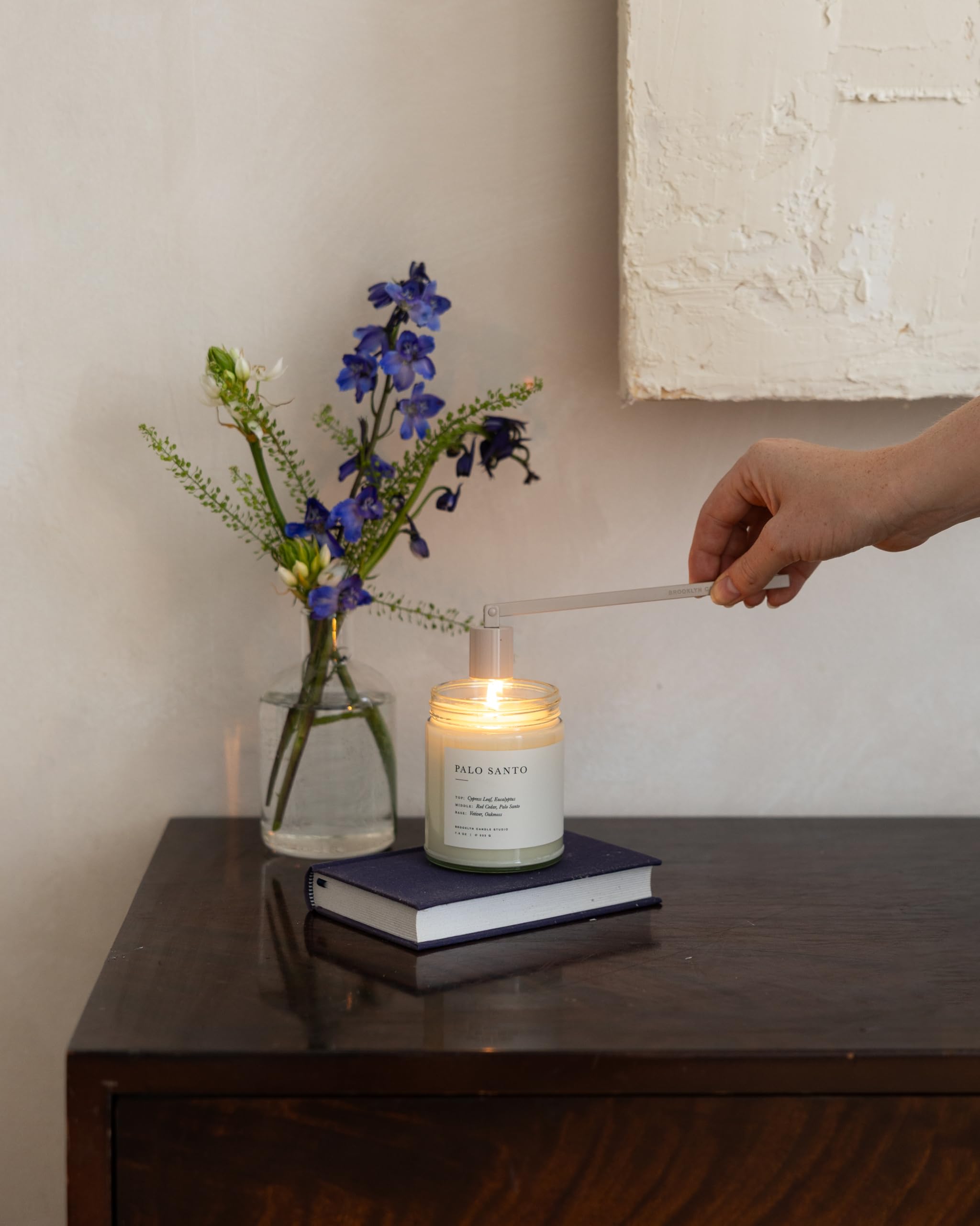 Brooklyn Candle Studio candle beside book to show compact size