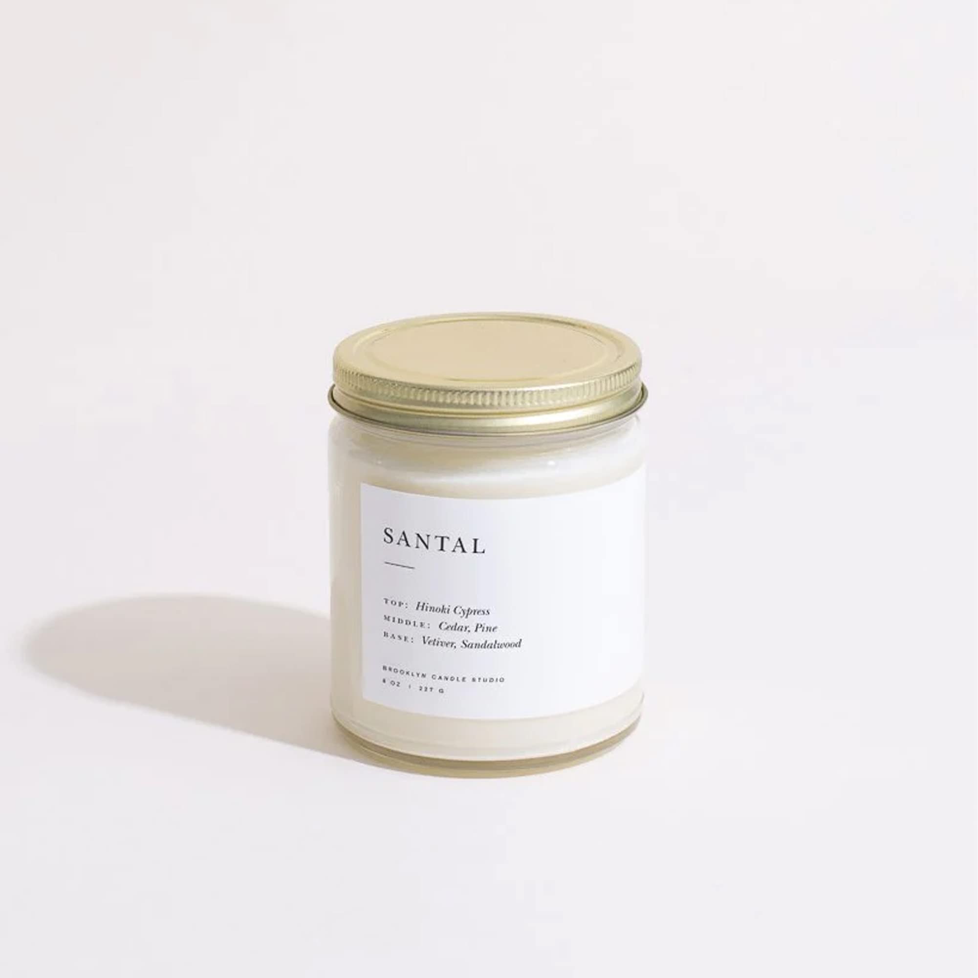 Brooklyn Candle Studio candle lit on mantel evokes warm ambiance benefit: cozy fragrance diffusion