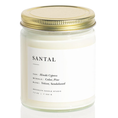 Brooklyn Candle Studio candle next to coffee mug shows scale benefit: compact for small spaces