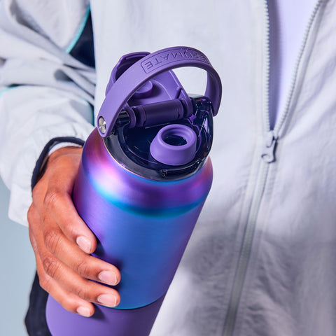 BrüMate Rise next to a standard water bottle for scale showing compact 25oz capacity advantage