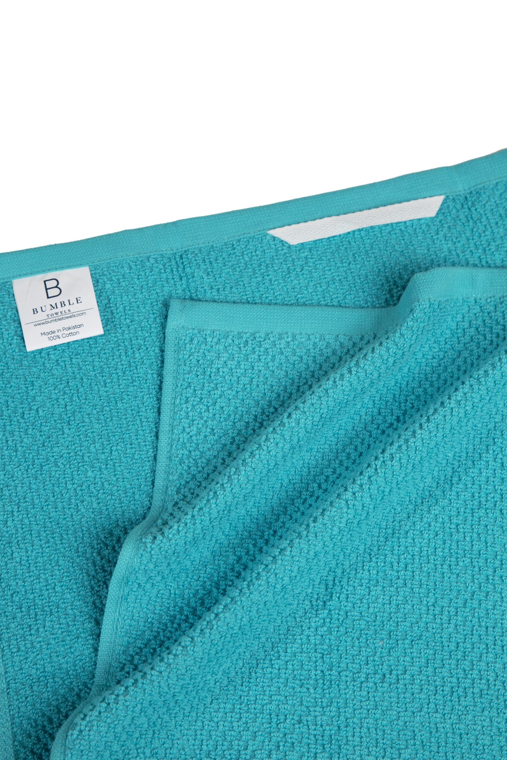 Bumble Towels folded and stacked on counter showing neat storage and quick access benefit