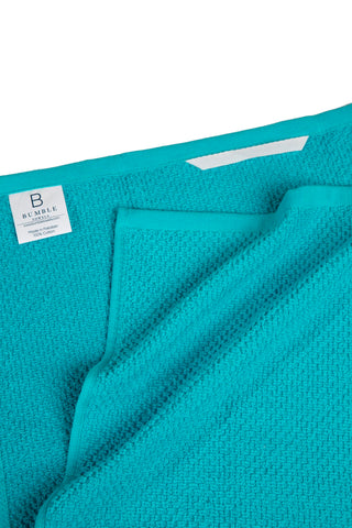 Bumble Towels folded and stacked on counter showing neat storage and quick access benefit