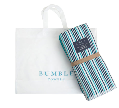 Bumble Towels next to utensils showing 16x26 size and practical coverage benefit