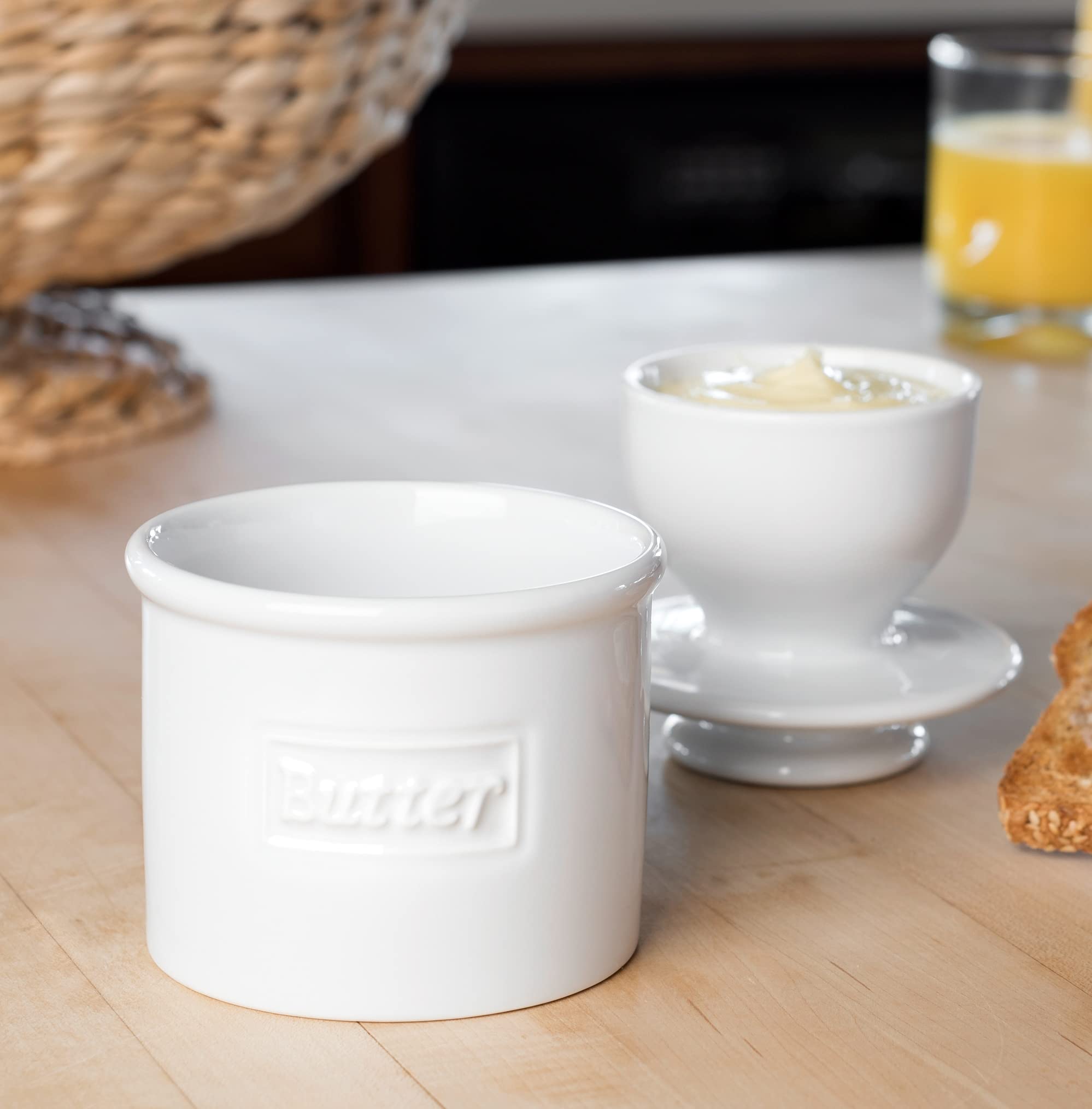 Butter Bell in use with knife spreading soft butter on warm bread for convenience