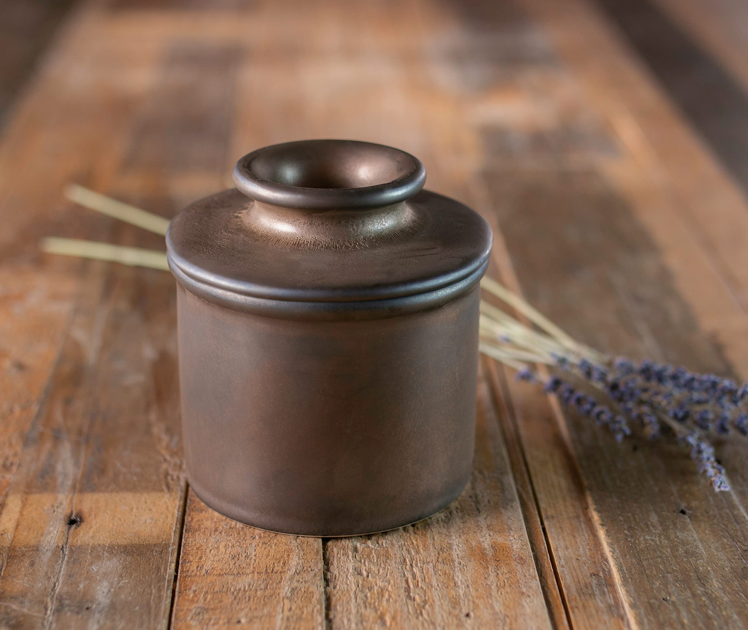 Butter Bell beside spoon showing scale for one-stick capacity and compact footprint