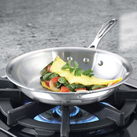 Calphalon omelette pan close-up of stainless interior and aluminum core layers, even-heating benefit