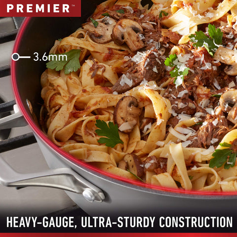 Calphalon pouring pasta water through lid demonstrating easy drainage
