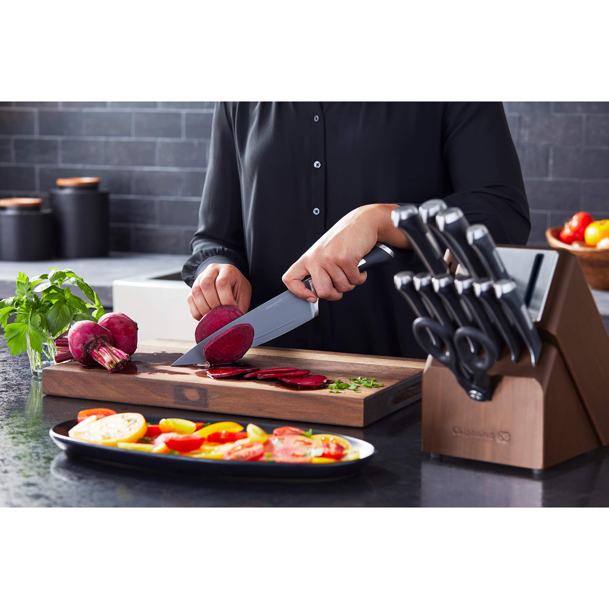 Calphalon chef knife held in hand to show scale and balanced full-tang feel