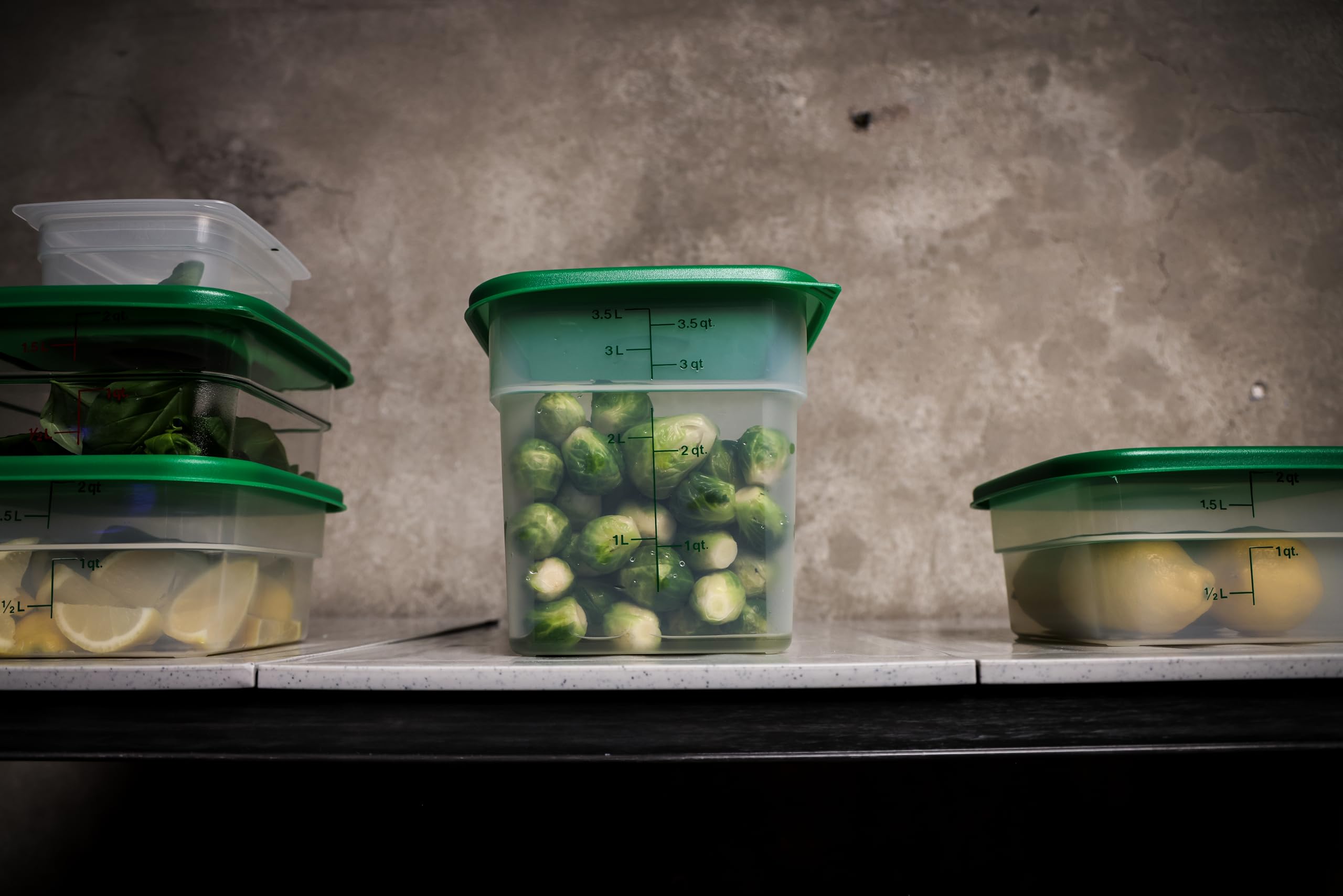 Cambro held in hand showing 4 quart scale and portability benefit