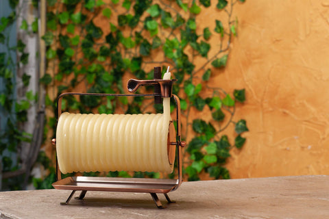 Candle by the Hour copper-tone stand and wick holder detail showing stable stylish display