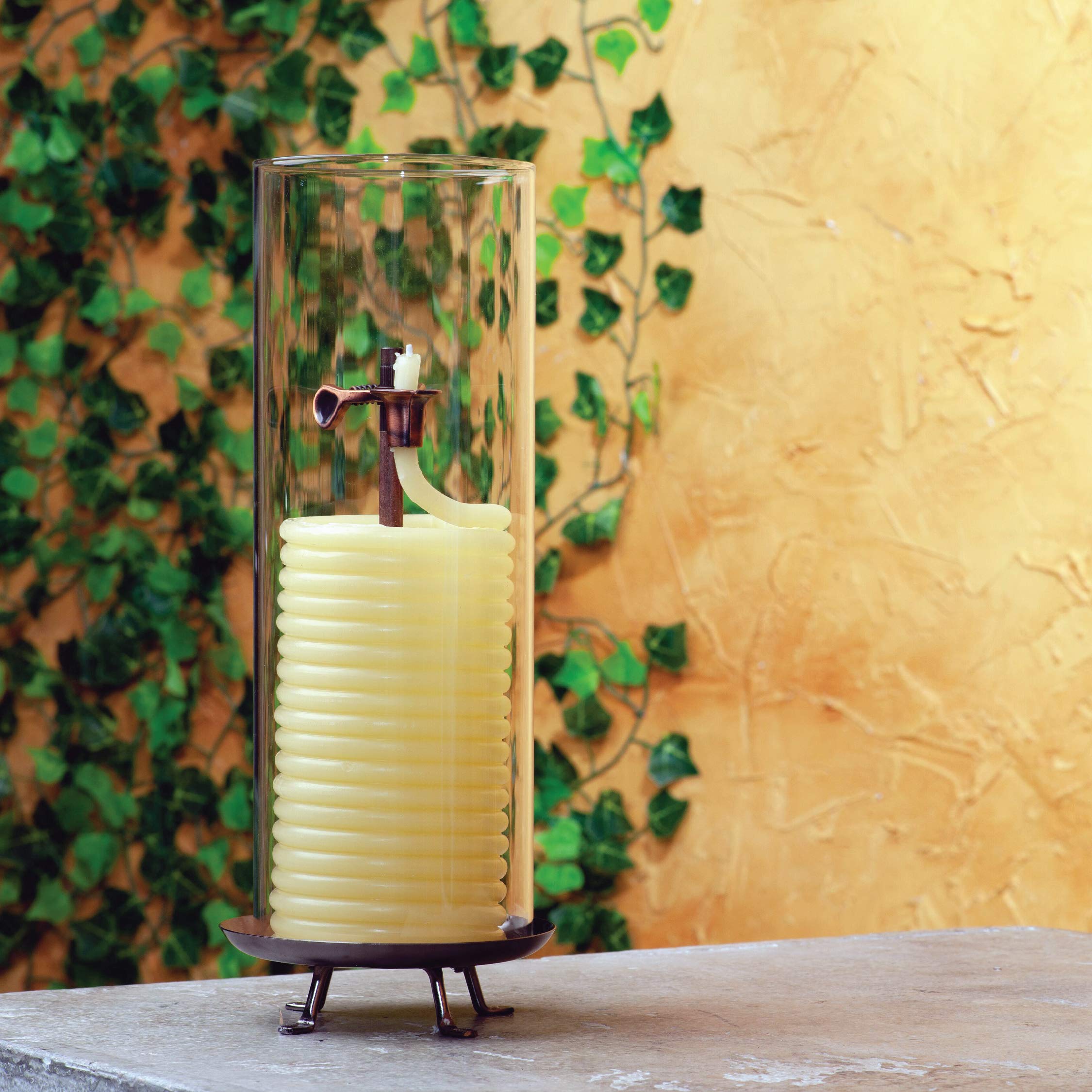 Candle by the Hour copper-tone wick clip detail, demonstrates safety self-extinguishing feature
