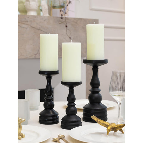 CANDWAX lit pillar candle in use conveying steady flame and warm ambiance