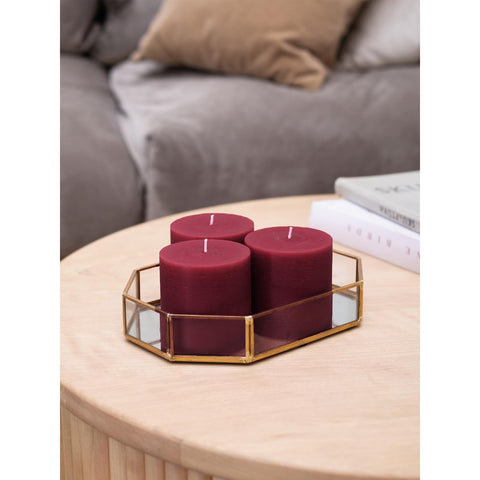 CANDWAX three pillars in a dining centerpiece showing ambiance benefit: warm event lighting