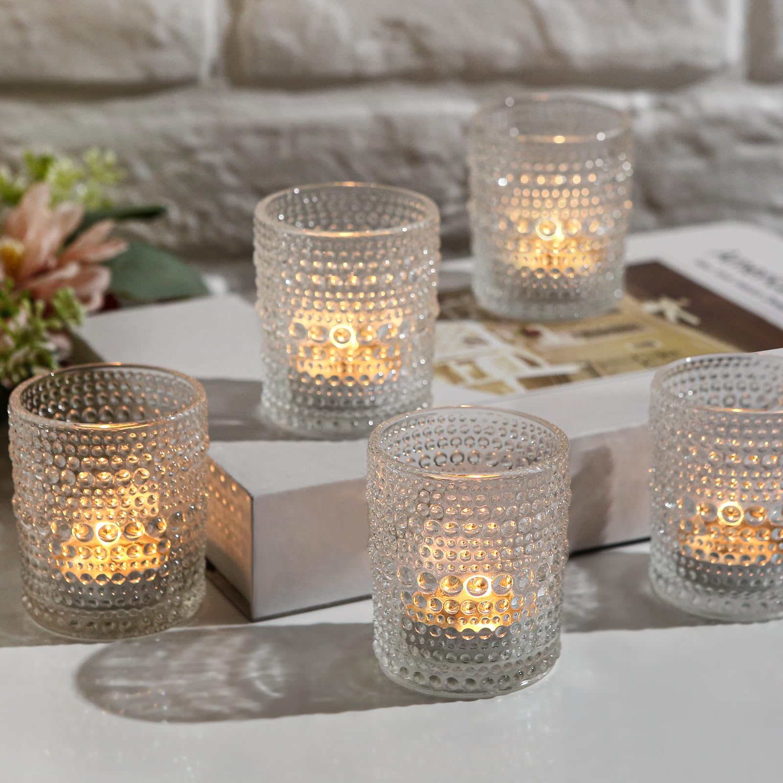 Capaniel votives displayed on mantel giving cozy evening ambience