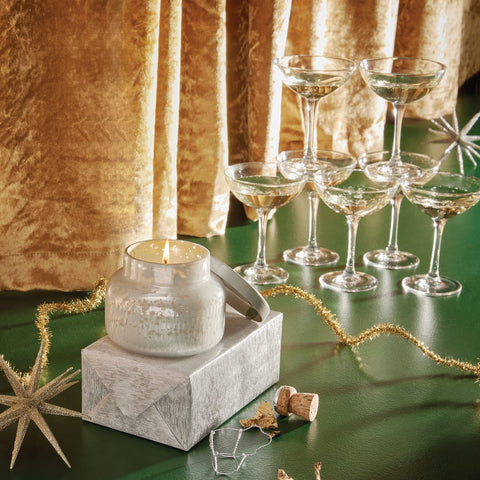 Capri Blue candle styled on mantle adding cozy holiday ambiance benefit