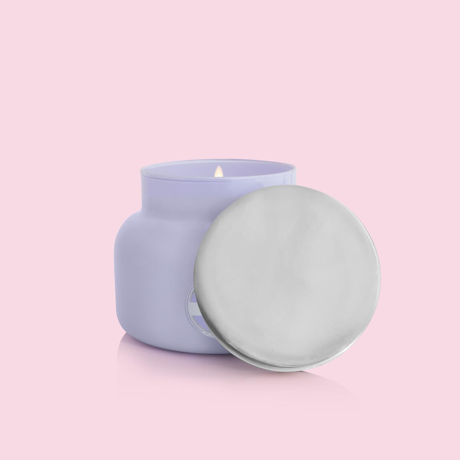Capri Blue candle on a cozy table setting creating inviting atmosphere and scent