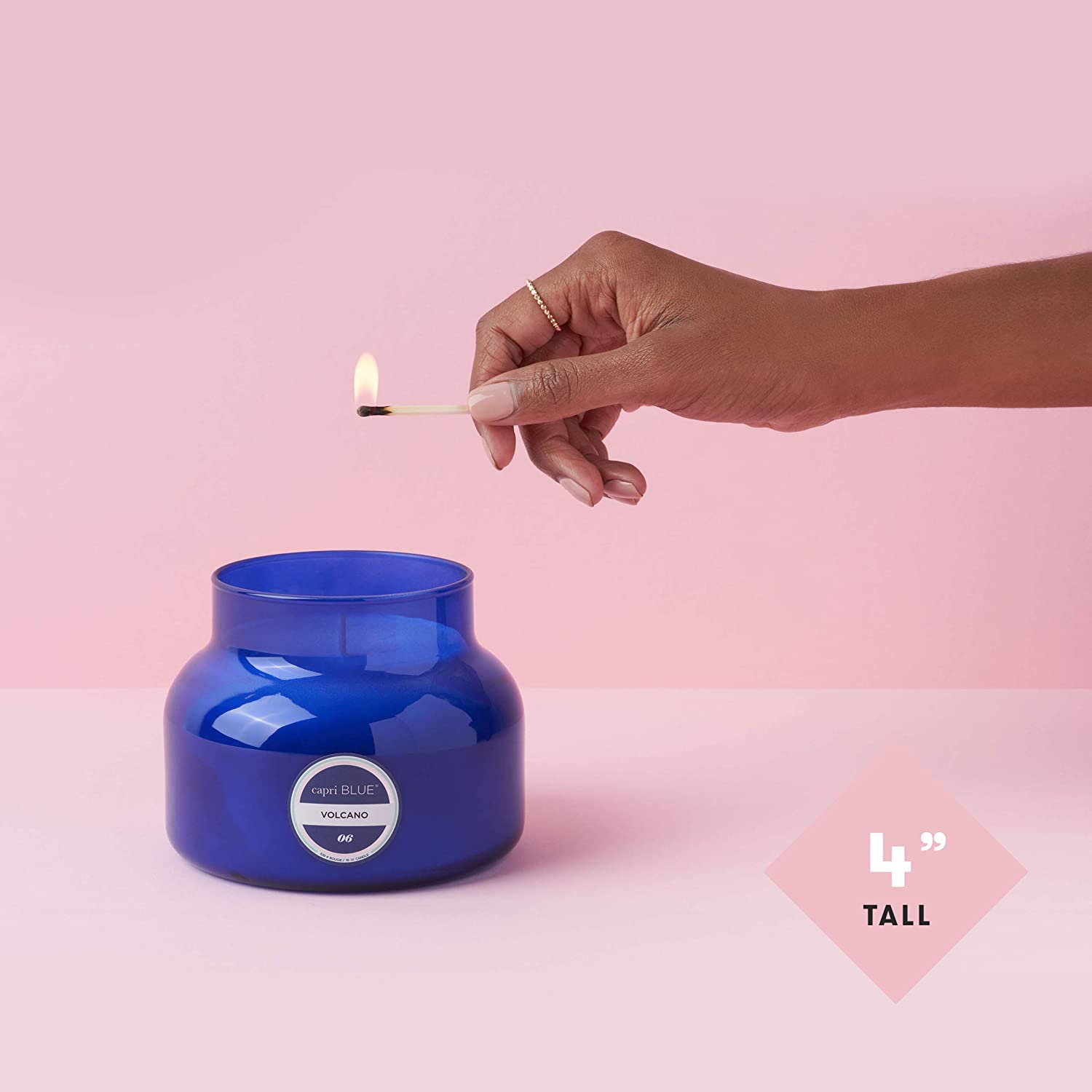 Capri Blue lit candle in living room creating inviting, long-lasting ambiance benefit