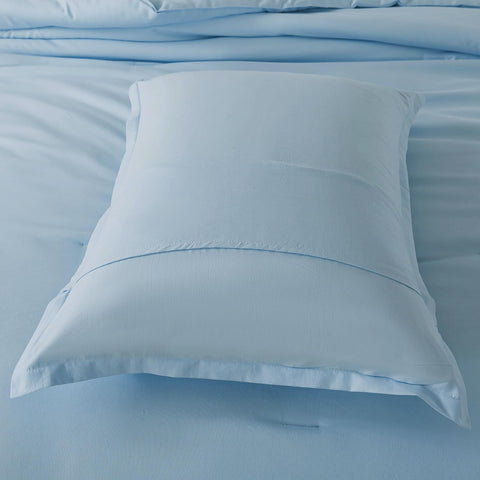 Caressma comforter size comparison with hand to illustrate twin dimensions and scale